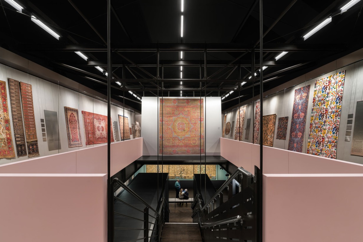Display cases in the Textiles and Carpets Collection featuring various objects