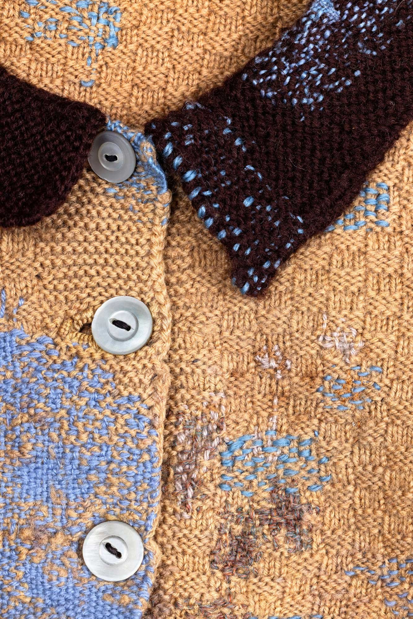 Original hand-knit damaged cardigan mended with various blue wools