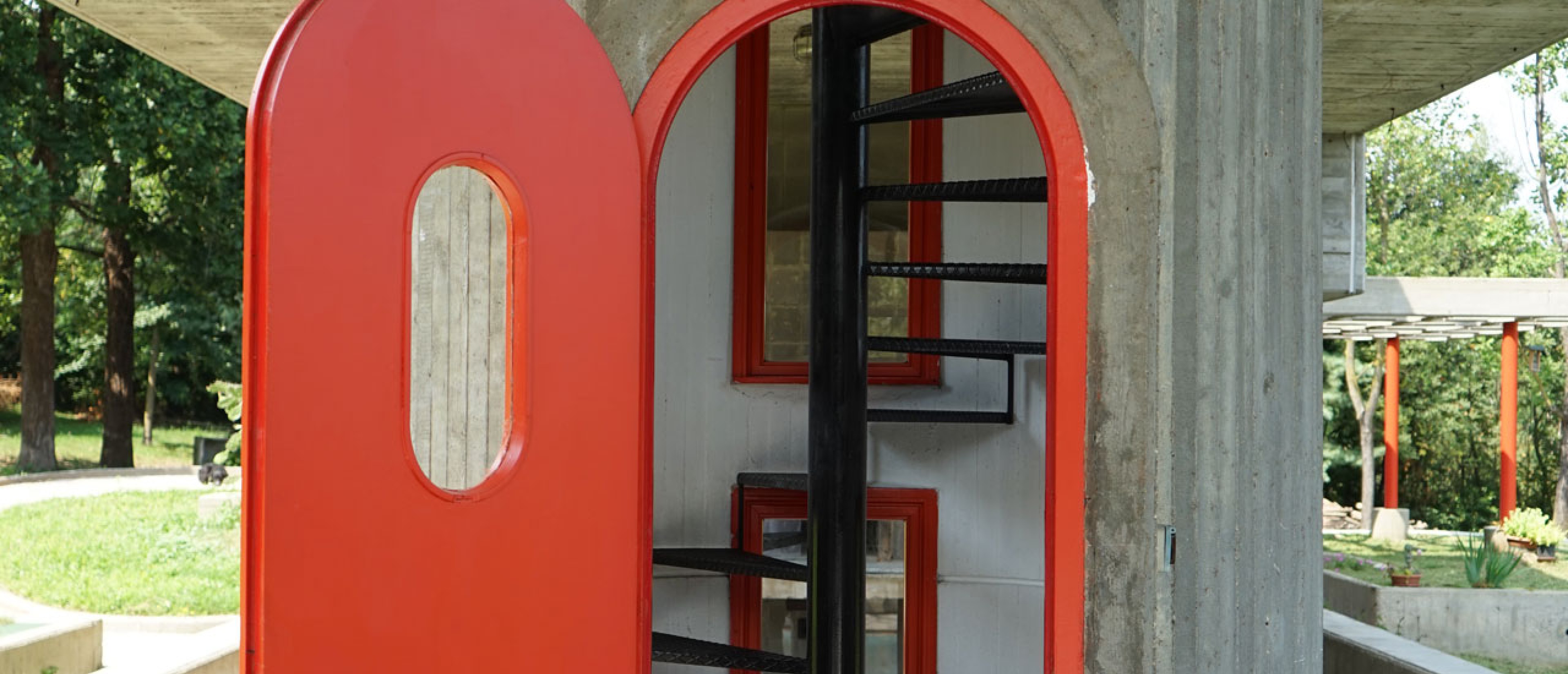 Red door with spiral staircase inside.
