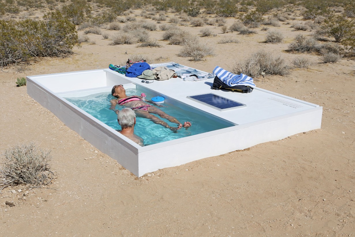 Pool with people in the desert
