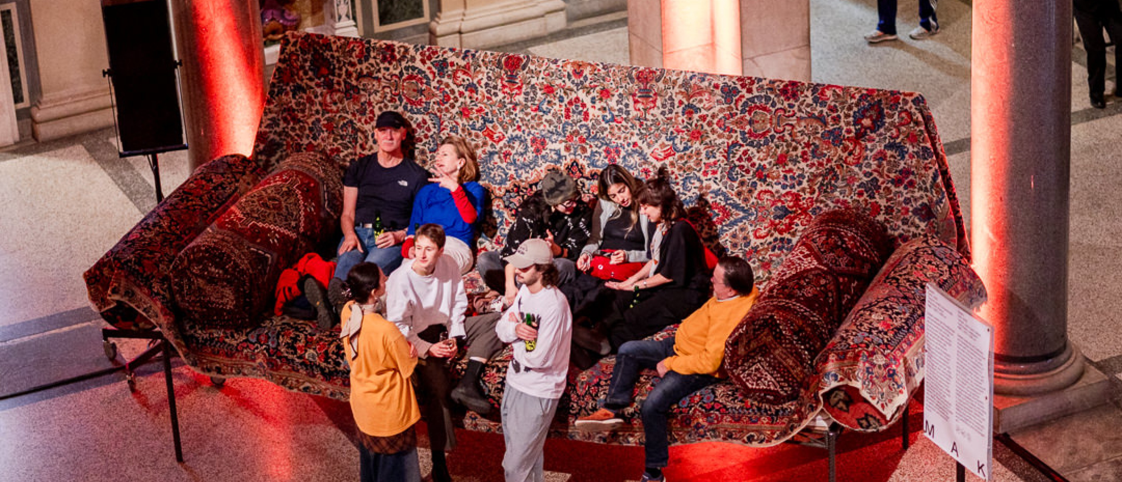 Besucher*innen auf einem überdimensionalen Sofa