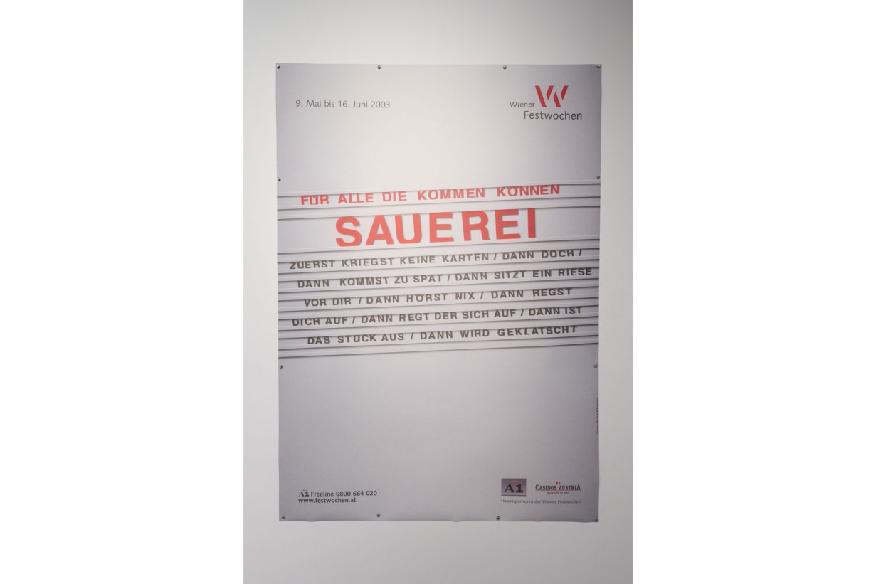 Wall with a large festival poster titled “Sauerei”