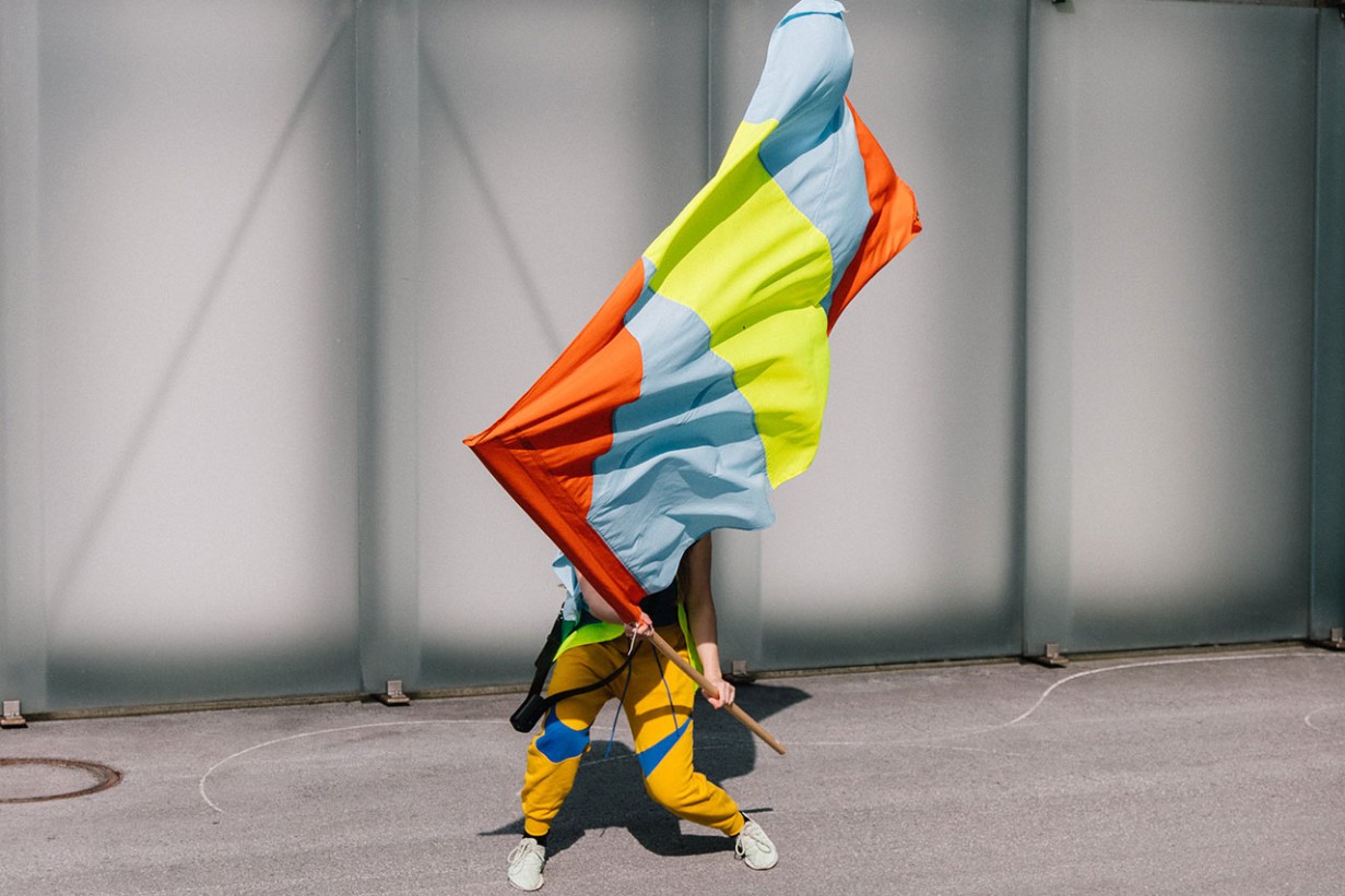 A person waves a colorful flag