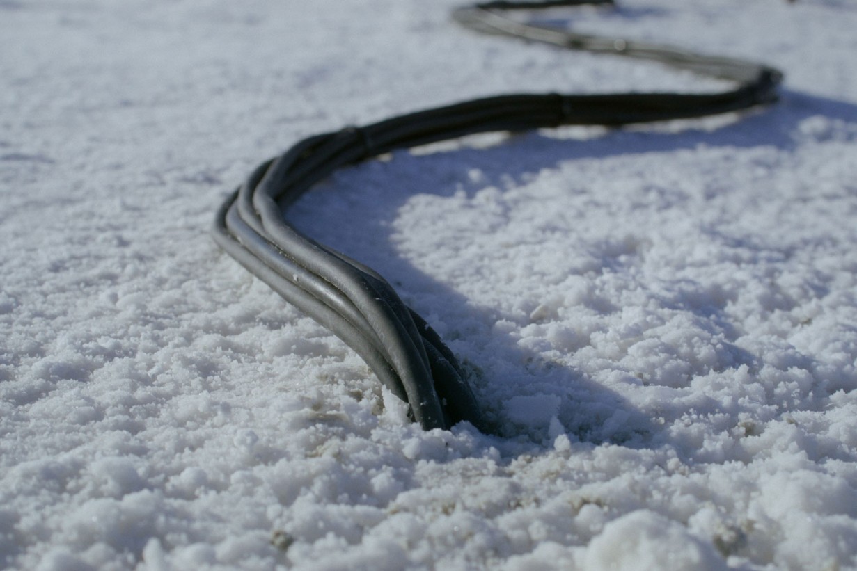 A computer cable in detail in a desert landscape.