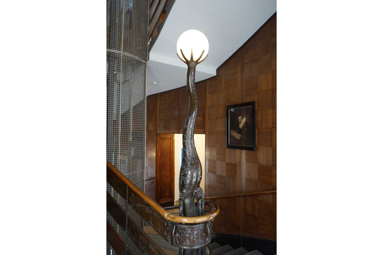 A decorative lamp on a railing that emits soft light 