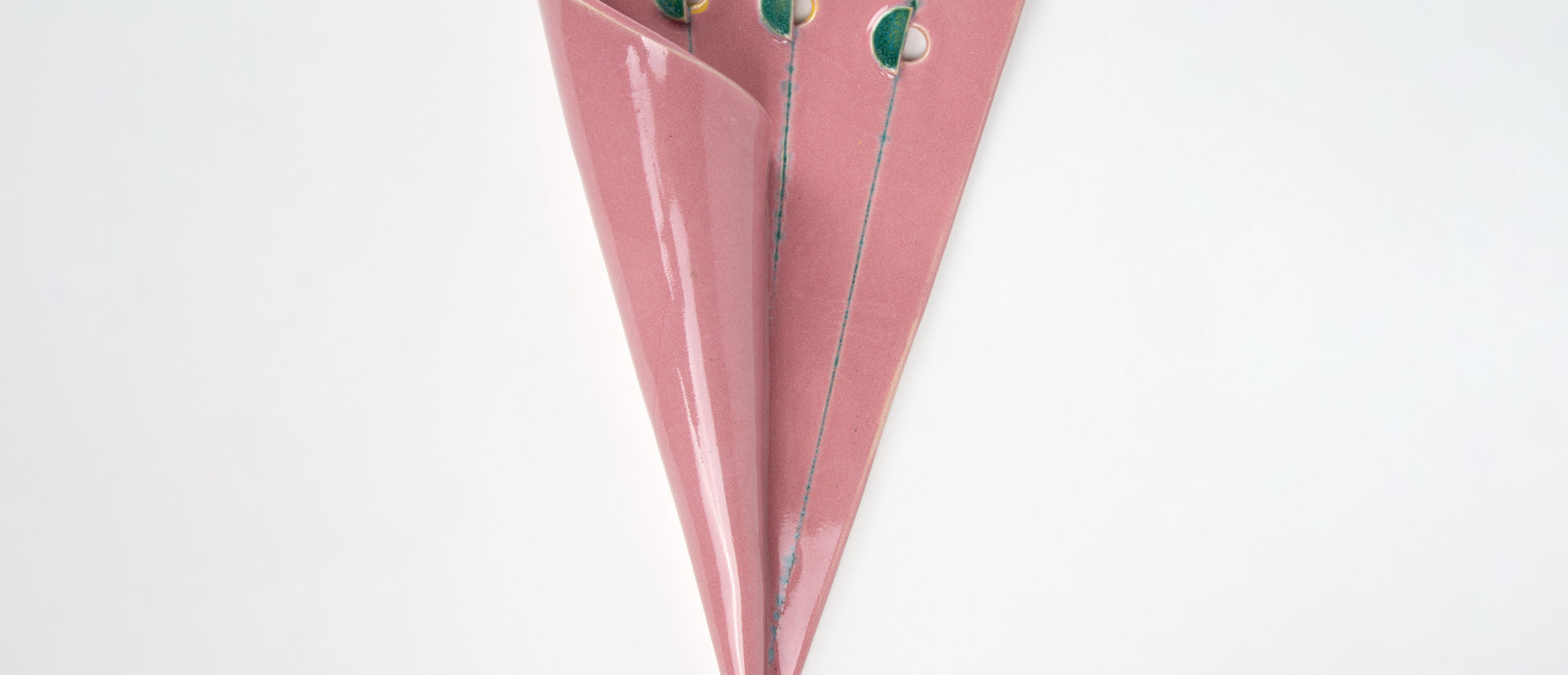 A pink ceramic object in the shape of an umbrella