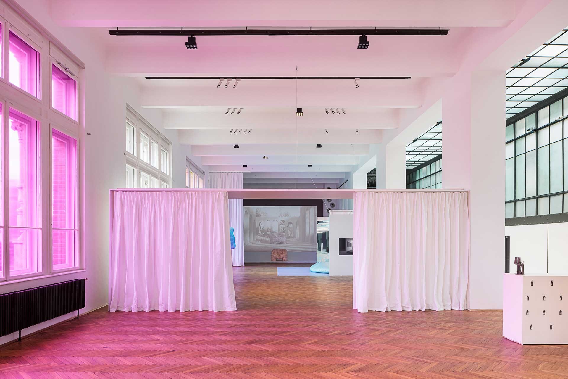 Exhibition hall bathed in pink light