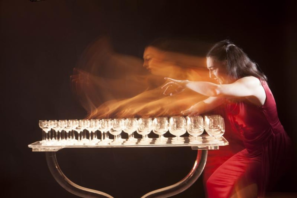 A woman makes music on glasses