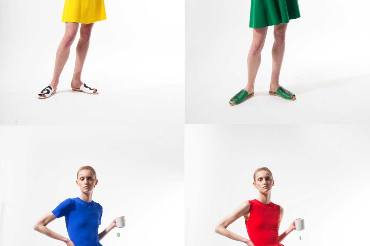 Four models in long shot, one model wears a yellow outfit, another a green one, yet another a blue one and one a red one.