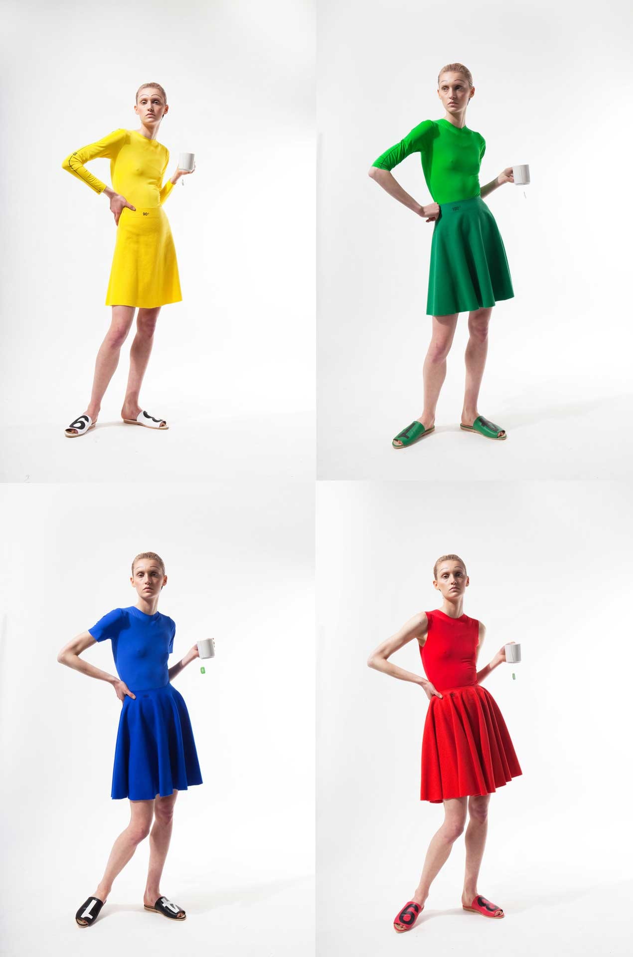 Four models in long shot, one model wears a yellow outfit, another a green one, yet another a blue one and one a red one.