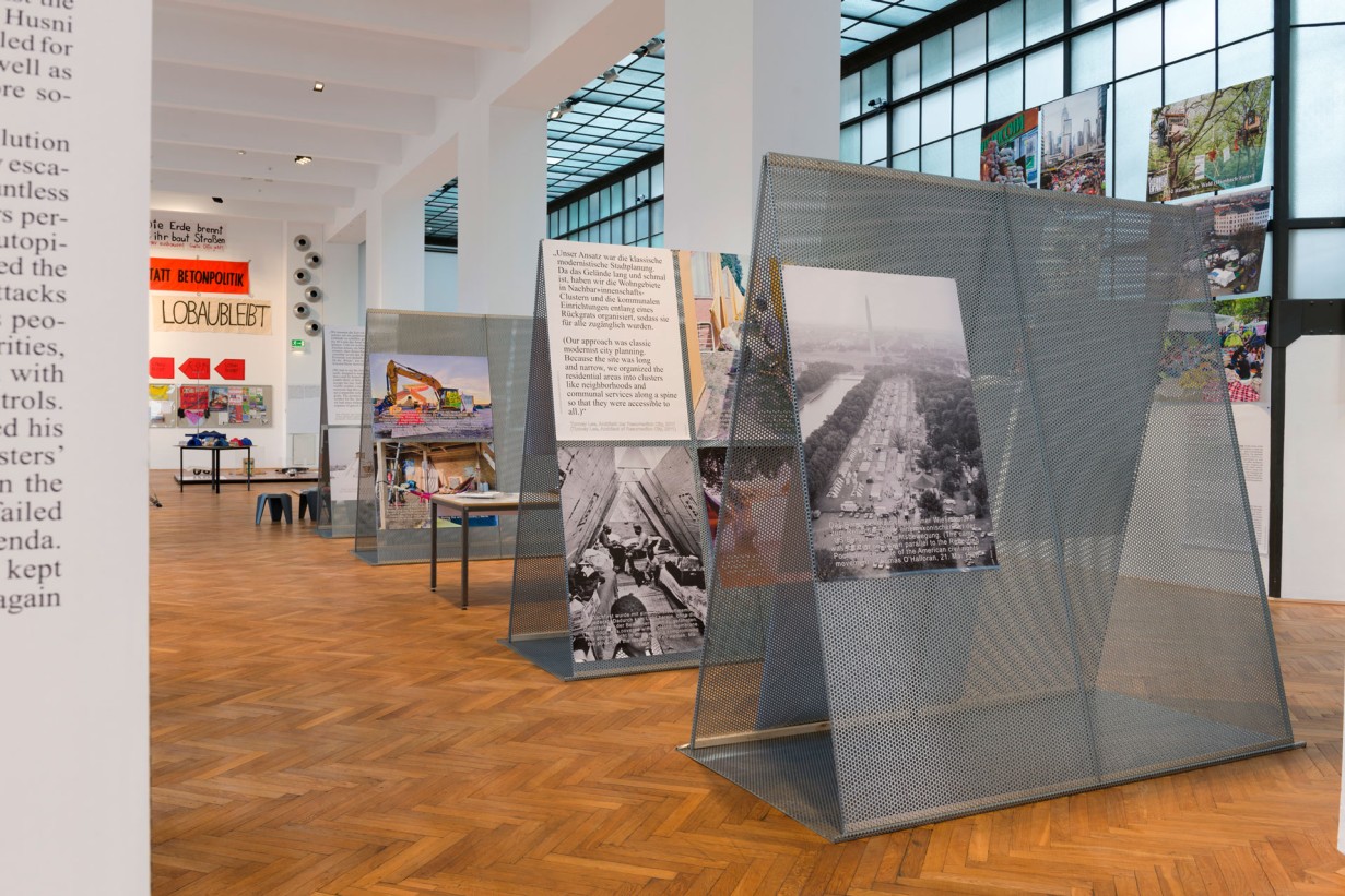 Exhibition space with barricades and posters