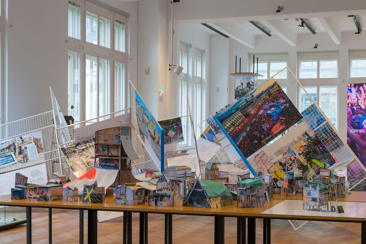 Exhibition room with miniature models of protest camps