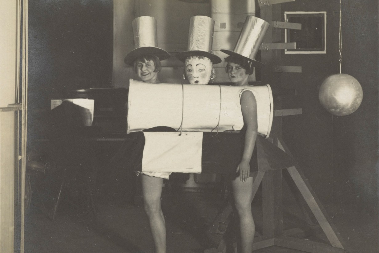 2 female students in top hat costumes