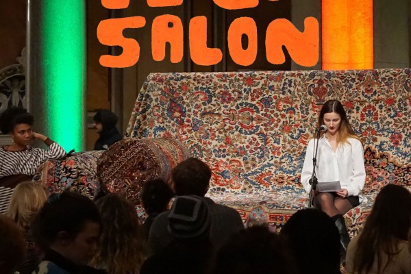 Person sitting on giant sofa reading