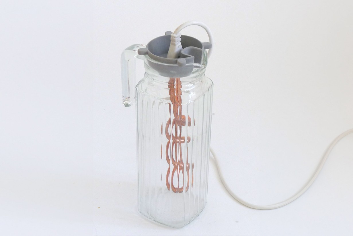 A glass bottle with a string attached to it
