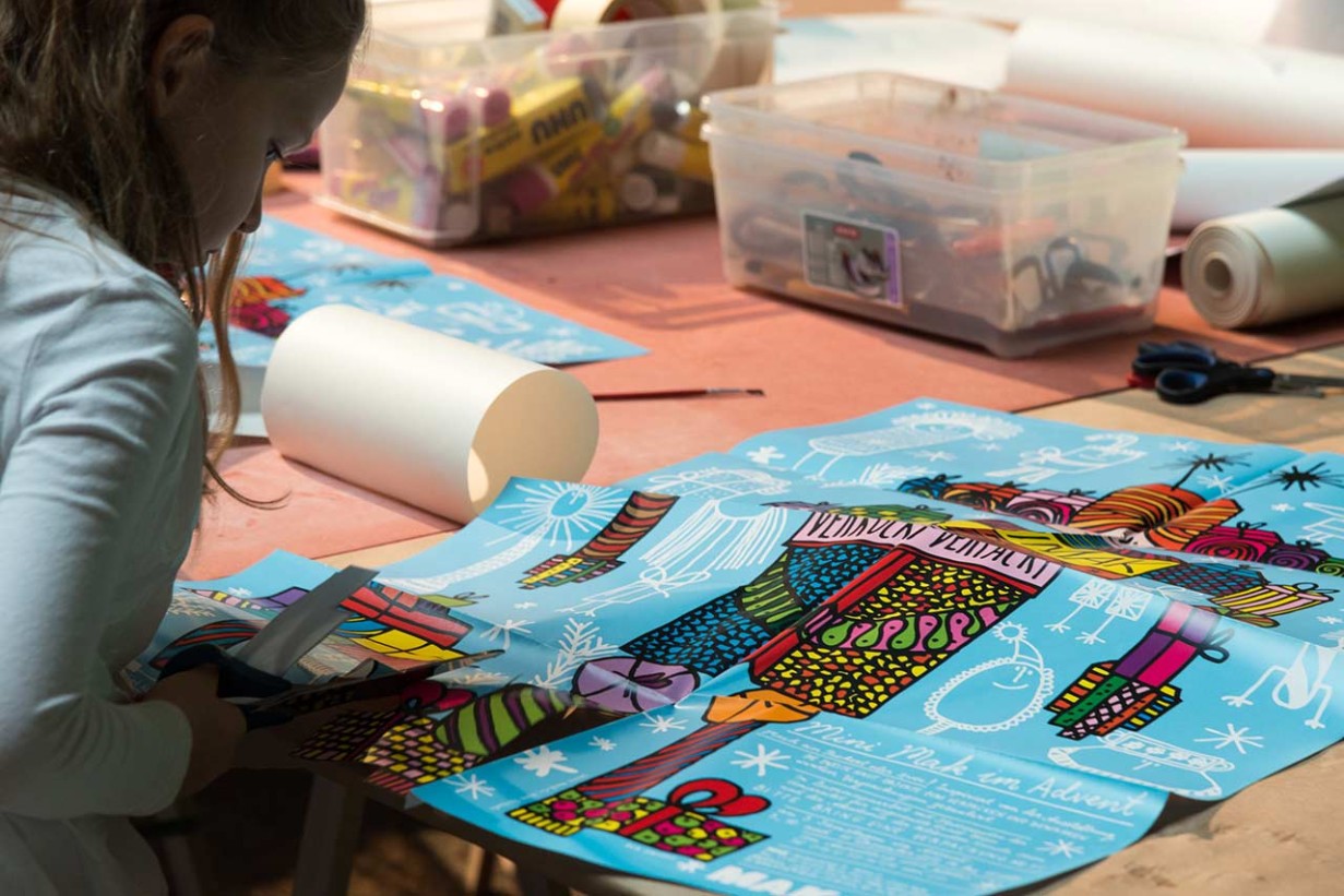A child cuts something out of a poster