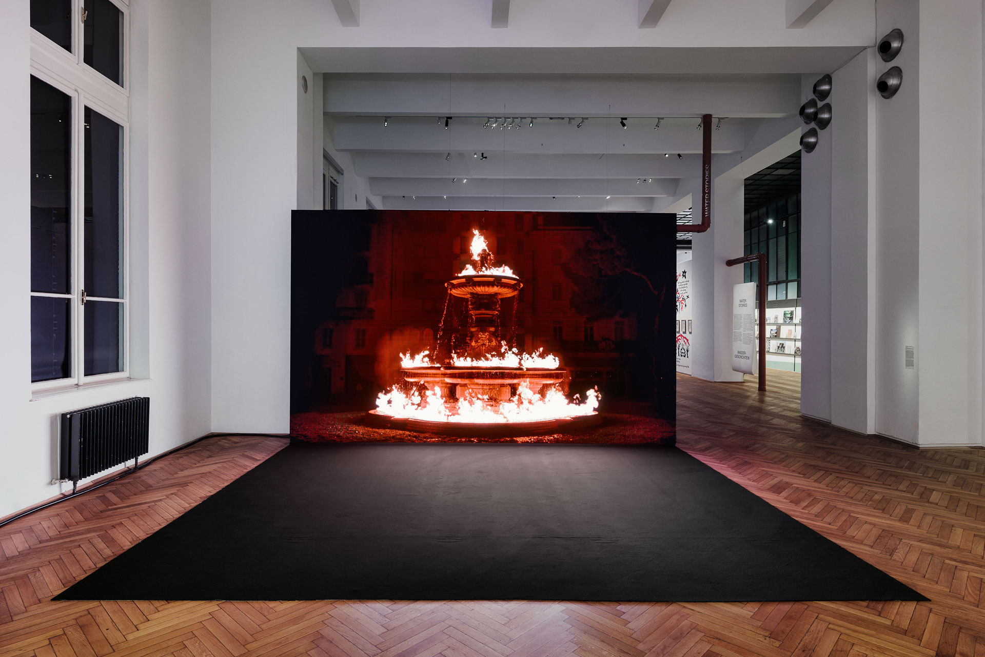 Exhibition hall, screen on which the burning fountain can be seen