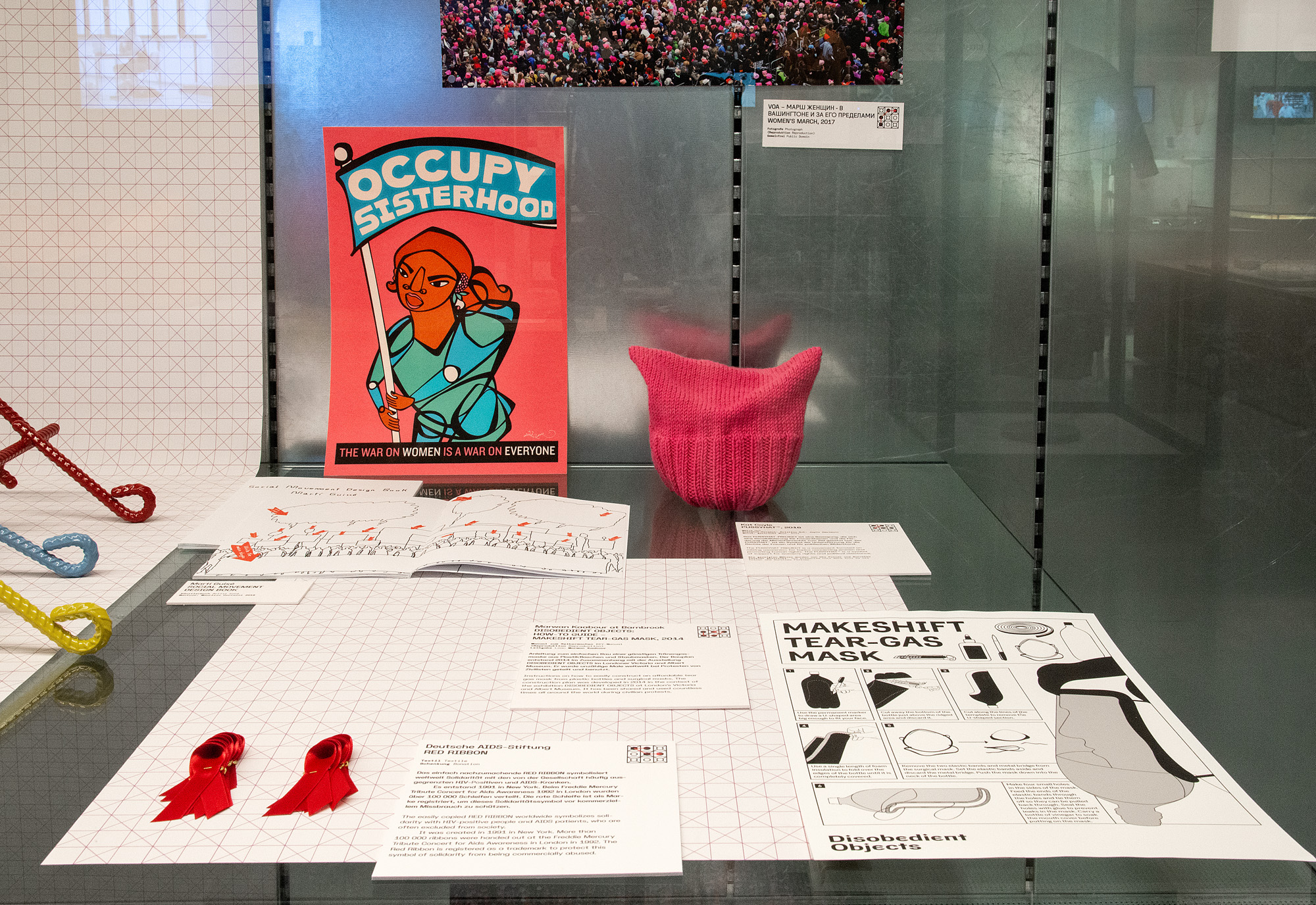 Display case with “Occupy Sisterhood” poster